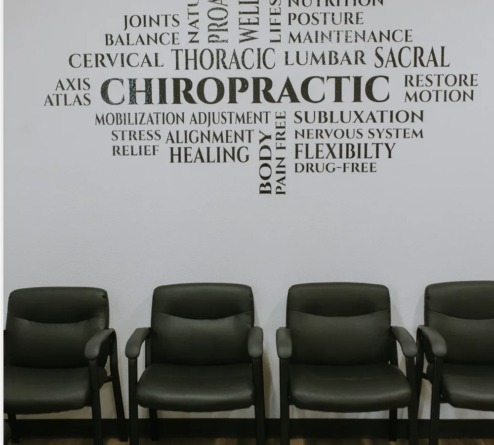 The waiting room at Yuba Sutter Chiropractic, with a wall of painted words around the word chiropractic