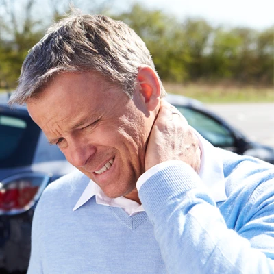 A man holding his neck in pain after an auto accident